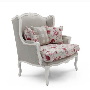 Klasična fotelja sa drvneim okvirom u bijeloj boji. Presvučena u materijal sive boje, leđni i sjedeći jastuci u cvijetnom uzorku. Može se naručiti u drugim bojama drva i materijala.